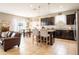 Open concept kitchen with breakfast bar, stainless appliances, and seamless flow into the living area at 8710 Rindge Rd, Polk City, FL 33868