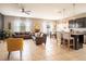 Open concept living area features kitchen, bar seating, and a cozy seating arrangement near bright windows at 8710 Rindge Rd, Polk City, FL 33868