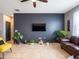 Inviting living room featuring a dark accent wall, tile flooring, and an abundance of natural light at 8710 Rindge Rd, Polk City, FL 33868