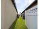 Side yard featuring healthy grass, privacy fence, and space between houses at 8710 Rindge Rd, Polk City, FL 33868