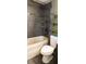 Nicely updated bathroom features a shower/tub combination with neutral wall tiles at 8767 Grandee Dr, Orlando, FL 32829