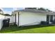 View of the home's back exterior, showcasing the well-maintained lawn and vinyl fence at 8767 Grandee Dr, Orlando, FL 32829