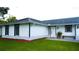 Charming single-story home featuring a well-manicured lawn and inviting front porch at 8767 Grandee Dr, Orlando, FL 32829