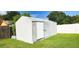 Exterior shot of the outdoor shed with a white door and siding at 8767 Grandee Dr, Orlando, FL 32829