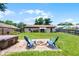 Spacious backyard featuring a fire pit, hot tub, and lush green lawn at 891 Licaria Dr, Ocoee, FL 34761