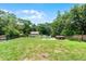 Large backyard with hot tub, fire pit area, storage shed and green space at 891 Licaria Dr, Ocoee, FL 34761