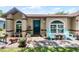 Charming home featuring a cozy front porch with blue chairs and decorative accents at 891 Licaria Dr, Ocoee, FL 34761