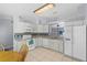 Well-lit kitchen featuring white cabinets, granite countertops, and modern appliances at 891 Licaria Dr, Ocoee, FL 34761