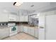 Well-equipped kitchen with white appliances, granite countertops, and a view to the dining area at 891 Licaria Dr, Ocoee, FL 34761