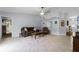 Open living room with vaulted ceilings, tile floors, stylish furniture, and neutral paint at 891 Licaria Dr, Ocoee, FL 34761