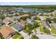 A high angle showing a beautiful residential community with mature landscaping and a large lake at 8920 Palisades Beach Ave, Orlando, FL 32829
