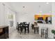 Bright dining area featuring a modern light fixture and views to the backyard through a large window at 8920 Palisades Beach Ave, Orlando, FL 32829