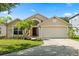 Charming single-Gathering home featuring a two-car garage and well-maintained landscaping with palm trees at 8920 Palisades Beach Ave, Orlando, FL 32829