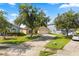 Well-maintained, single-story home with mature trees, landscaped yard, and long driveway at 8920 Palisades Beach Ave, Orlando, FL 32829