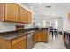Kitchen view highlights granite countertops, stainless steel appliances, and a pass-through to the dining area at 8920 Palisades Beach Ave, Orlando, FL 32829