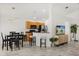 An open-concept kitchen, dining table and living room space with bar stool seating, stainless steel appliances at 8920 Palisades Beach Ave, Orlando, FL 32829