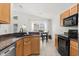 Kitchen view highlights granite countertops, stainless steel appliances, and opens to a dining area at 8920 Palisades Beach Ave, Orlando, FL 32829