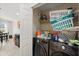 Laundry room area with updated front load washer and dryer set and ample shelving at 8920 Palisades Beach Ave, Orlando, FL 32829