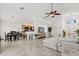 Open-concept living space with tile floors, vaulted ceilings, a dining table and a view of the kitchen at 8920 Palisades Beach Ave, Orlando, FL 32829
