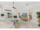 Spacious living room with vaulted ceilings, tile flooring, comfortable sofa, and a view to the backyard at 8920 Palisades Beach Ave, Orlando, FL 32829