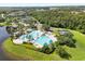 An aerial view highlighting the community's pool, tennis courts, splash pad, and surrounding landscape at 8920 Palisades Beach Ave, Orlando, FL 32829