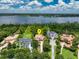 Aerial view of an estate home surrounded by lush greenery and a serene lake at 9253 Tibet Pointe Cir, Windermere, FL 34786