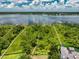 Aerial view of waterfront property featuring docks, pathways, and lush greenery surrounding the home at 9253 Tibet Pointe Cir, Windermere, FL 34786
