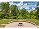 Backyard featuring a brick firepit area and a wooded area with a walkway at 9253 Tibet Pointe Cir, Windermere, FL 34786