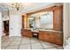 Elegant bathroom featuring granite countertops, dark wood cabinetry, and decorative tile flooring at 9253 Tibet Pointe Cir, Windermere, FL 34786