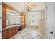 Spacious bathroom with double vanity, soaking tub, and elegant design features like arched window at 9253 Tibet Pointe Cir, Windermere, FL 34786