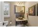 The powder room features a bowl sink and ornate wrought iron vanity at 9253 Tibet Pointe Cir, Windermere, FL 34786