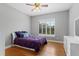 Bedroom featuring hardwood floors, plantation shutters, and a ceiling fan at 9253 Tibet Pointe Cir, Windermere, FL 34786