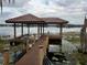 Waterfront home with a private boat dock with composite decking and tile roof offers access to the beautiful lake at 9253 Tibet Pointe Cir, Windermere, FL 34786
