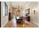 Elegant dining room with a chandelier, large window, and decorative details at 9253 Tibet Pointe Cir, Windermere, FL 34786