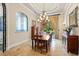 Elegant dining room with a chandelier, large window, and decorative details at 9253 Tibet Pointe Cir, Windermere, FL 34786