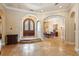 Spacious foyer featuring stone floors and arched entrances to adjacent living areas at 9253 Tibet Pointe Cir, Windermere, FL 34786