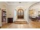 Grand foyer with arched doorways, stone floors, and a view of the formal dining room at 9253 Tibet Pointe Cir, Windermere, FL 34786