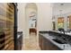 Hallway wet bar with dark cabinets, granite countertop, and wine cooler at 9253 Tibet Pointe Cir, Windermere, FL 34786