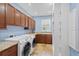 Well-equipped laundry room with modern appliances, built-in cabinets, sink, and shelving at 9253 Tibet Pointe Cir, Windermere, FL 34786