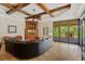 Elegant living room with coffered ceiling, fireplace, and sliding glass doors to outdoor living space at 9253 Tibet Pointe Cir, Windermere, FL 34786