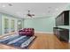 Spacious living room featuring hardwood flooring, recessed lights, wet bar, and backyard access at 9253 Tibet Pointe Cir, Windermere, FL 34786