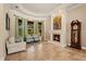 Elegant living room with a fireplace, stone floors, and bright, airy windows at 9253 Tibet Pointe Cir, Windermere, FL 34786
