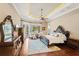 Comfortable bedroom showcasing a luxe bed, a ceiling fan, balcony access, and well-crafted wood furnishings at 9253 Tibet Pointe Cir, Windermere, FL 34786