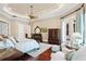 Relaxing main bedroom featuring a plush bed, a ceiling fan, sitting chairs, and balcony access at 9253 Tibet Pointe Cir, Windermere, FL 34786