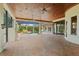 A spacious outdoor area with brick flooring, a fireplace, and a view of the pool at 9253 Tibet Pointe Cir, Windermere, FL 34786