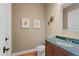 Charming powder room with decorative art, marble countertop, and wood flooring at 9253 Tibet Pointe Cir, Windermere, FL 34786