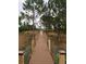 A long wood walkway with cable railing runs through the natural landscape, offering a peaceful and scenic view at 9253 Tibet Pointe Cir, Windermere, FL 34786