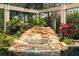 Rock waterfall feature and lush landscaping enhance the beauty of this screened-in pool area at 9253 Tibet Pointe Cir, Windermere, FL 34786