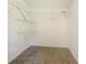 Walk-in closet featuring multiple shelves and carpet flooring at 947 Bird Bay Ct # 205, Lake Mary, FL 32746