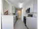 A modern kitchen with new appliances, quartz countertops, and light gray cabinetry at 947 Bird Bay Ct # 205, Lake Mary, FL 32746